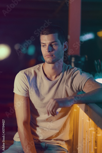 Close-up portrait of attractive male model. Young handsome man in a bar