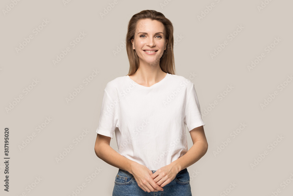 Fototapeta premium Portrait of smiling millennial woman posing for picture in studio