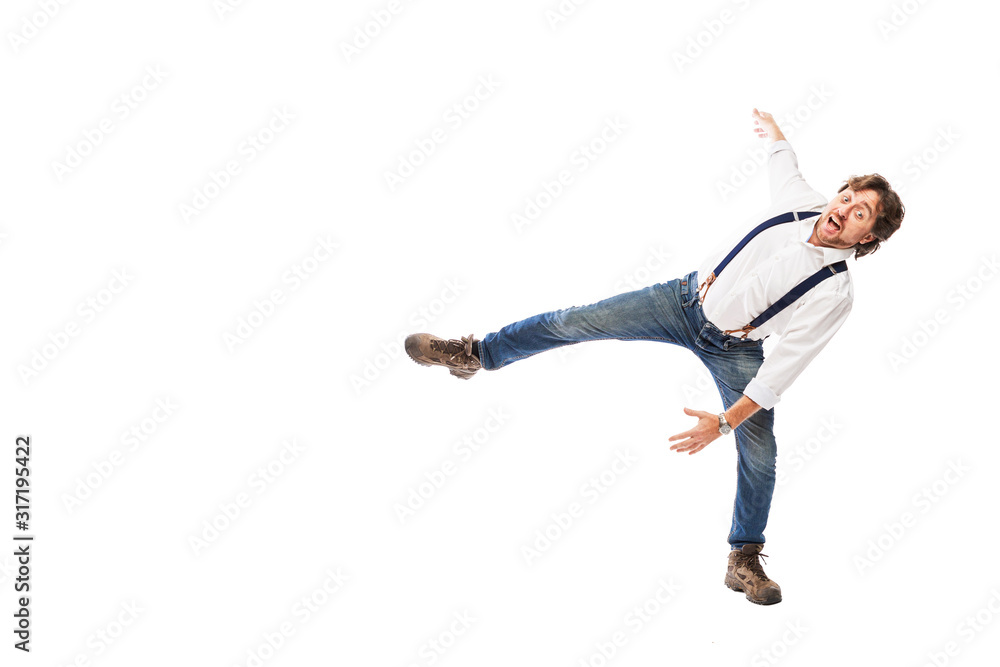 Smiling man with a beard in a white shirt and jeans is falling. Full height. Isolated on a white background. Space for text.