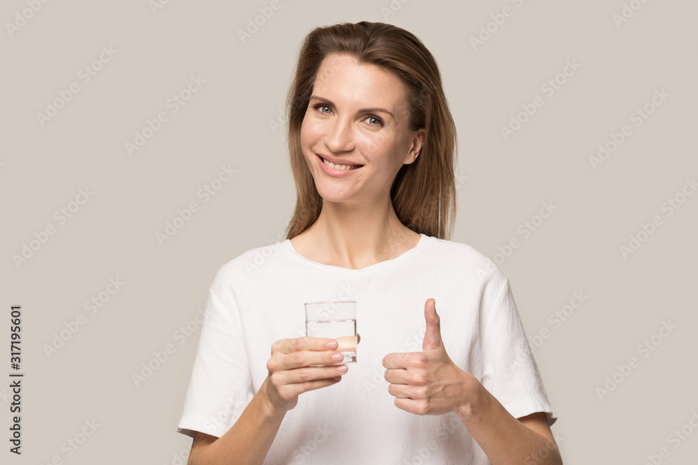 Smiling young woman with water glass recommend healthy lifestyle Smiling young woman with water glass recommend healthy lifestyle