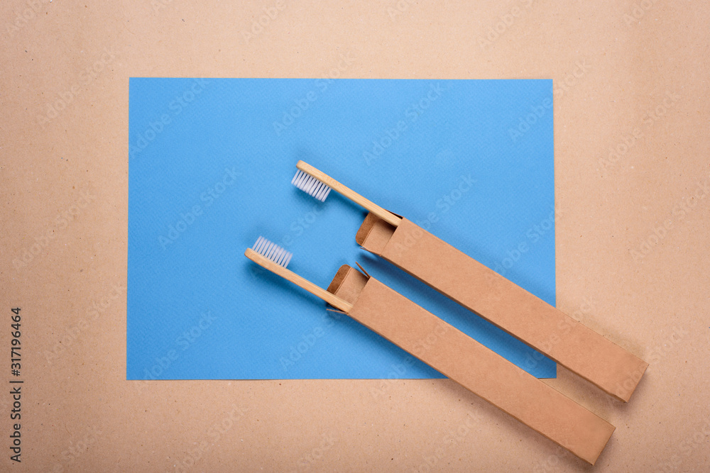 Bamboo toothbrushes on blue background, top view Bamboo toothbrushes on blue background, top view
