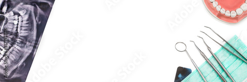 Banner made from dentist tools on mask and x-ray photo isolated on white background. Flat lay.