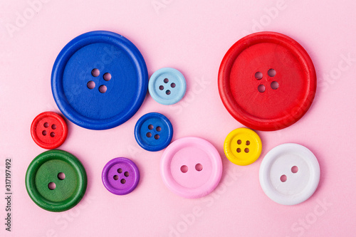 Pastel plastic buttons on pink