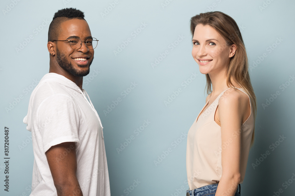 Smiling multiracial people posing isolated on studio background Smiling multiracial people posing isolated on studio background