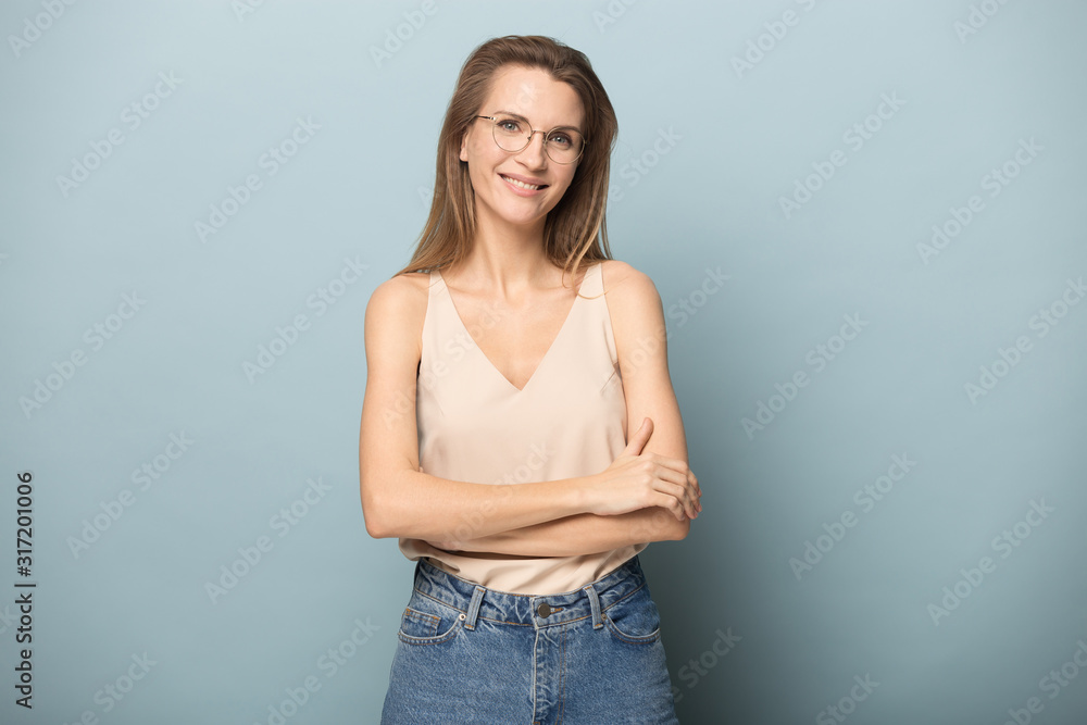 Smiling young woman in glasses stand isolated in studio Smiling young woman in glasses stand isolated in studio