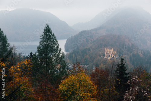 Landscape picture of Neuschwanstein castle near Munich in Bavaria, Germany in Autumn with colorful trees