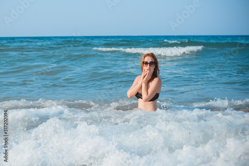 Plus size nice young woman with full hips and pretty figure in fashionable swimsuit rest at sea, vacation and trip concept © T.Den_Team