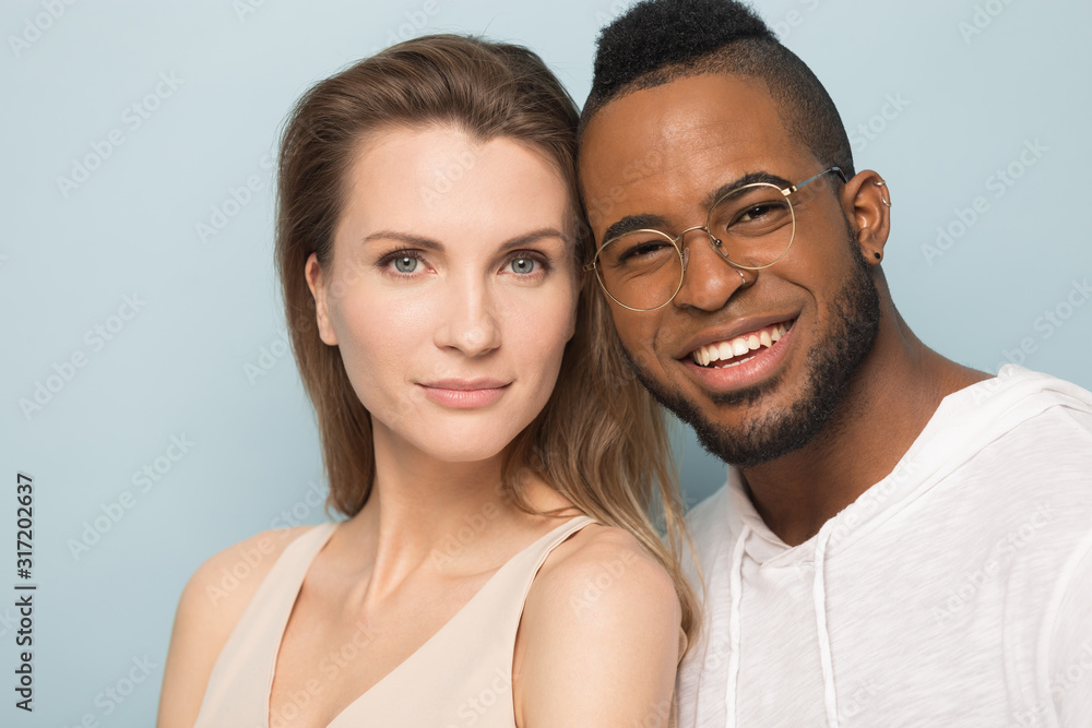 Happy multicultural couple posing for portrait in studio Happy multicultural couple posing for portrait in studio