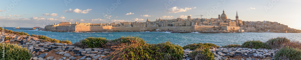 Panoramic view of Valletta, seafront skyline of the capital city of Malta from Sliema shoreline with green flora