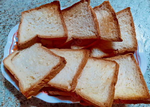 A set of m breads with eight slices slides placed on a homemade white plate