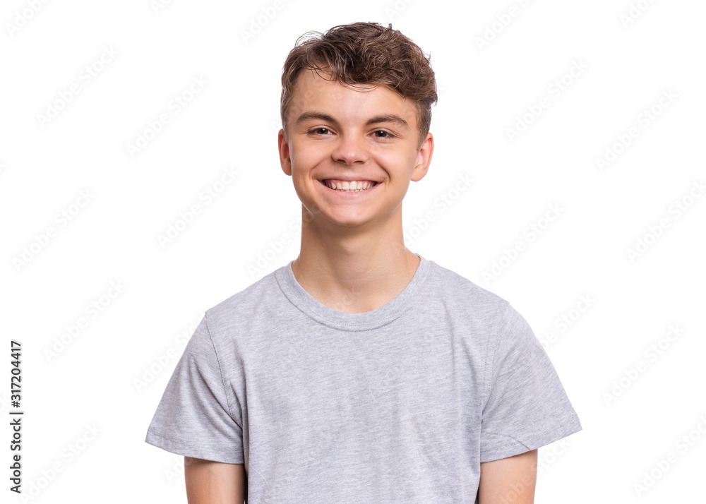 T-shirt design concept. Teen boy in blank gray t-shirt, isolated on white background. Mock up template for print. Happy child looking at camera, front view. T-shirt design concept. Teen boy in blank gray t-shirt, isolated on white background. Mock up template for print. Happy child looking at camera, front view.