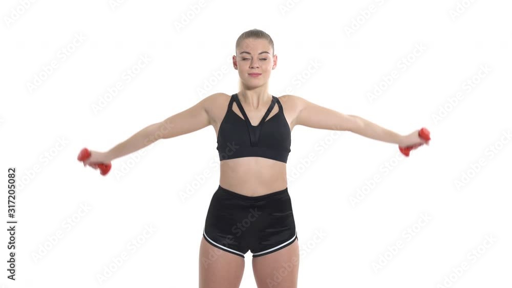 Close-up portrait shot of a beautiful blonde sports woman with ponytail performing fitness exercises using dumbbells. Professional sport concept Close-up portrait shot of a beautiful blonde sports woman with ponytail performing fitness exercises using dumbbells. Professional sport concept