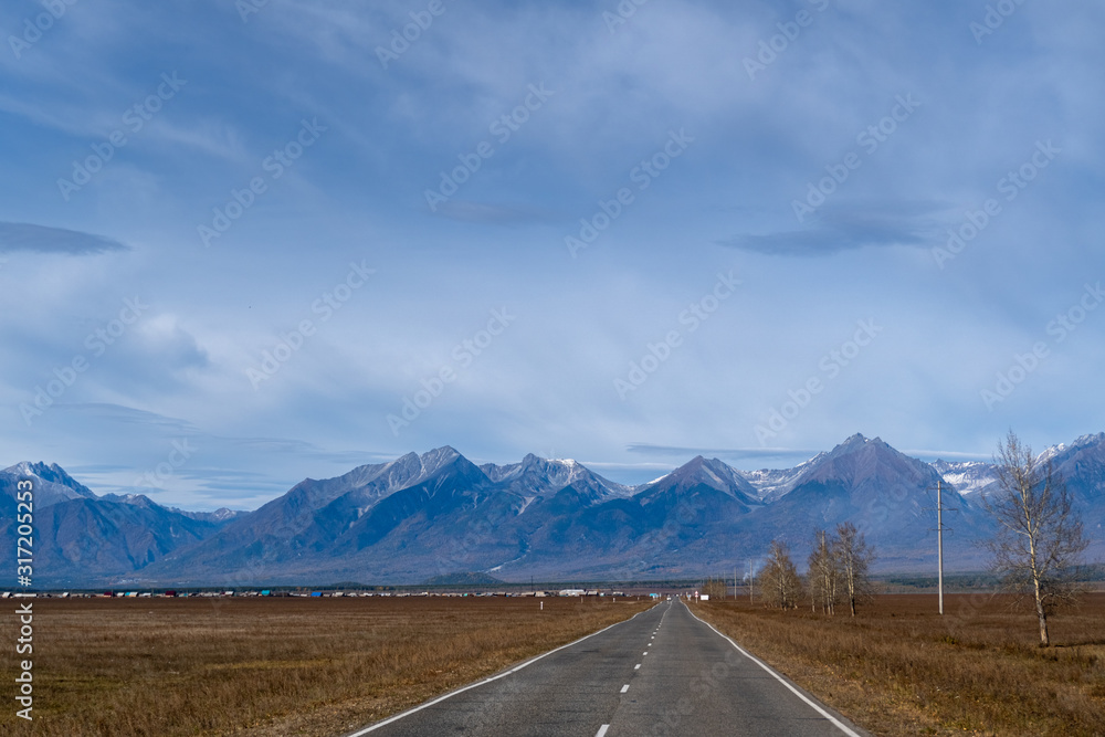 Highway in Tunka Valley with mountains in the background