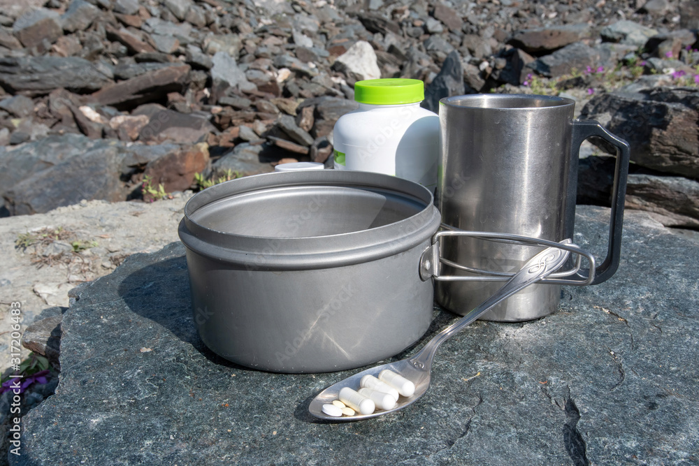 Sports nutrition for climbers. Breakfast for climbers and hikers on the stone table in alpine landscape. Sports nutrition for climbers. Breakfast for climbers and hikers on the stone table in alpine landscape.