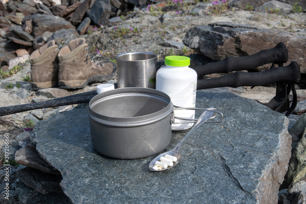 Sports nutrition for climbers. Breakfast for climbers and hikers on the stone table in alpine landscape. Sports nutrition for climbers. Breakfast for climbers and hikers on the stone table in alpine landscape.