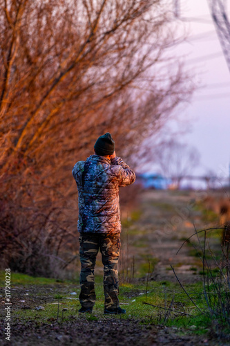 Professional wildlife photographer in camouflage clothing © czamfir