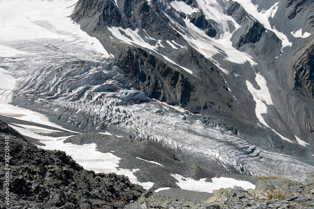 Alpine landscape. View at open, uncovered with snow glacier.