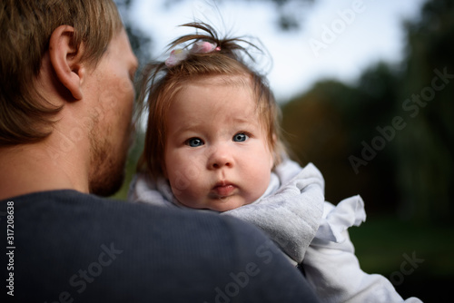 Young father having fun with his little daughter in park