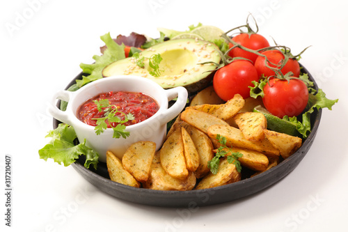 plate of french fries, salad and tomato sauce isolated on white background