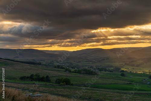 A cloudy sunset in the Yorkshire Dales near Countersett, North Yorkshire, England, UK