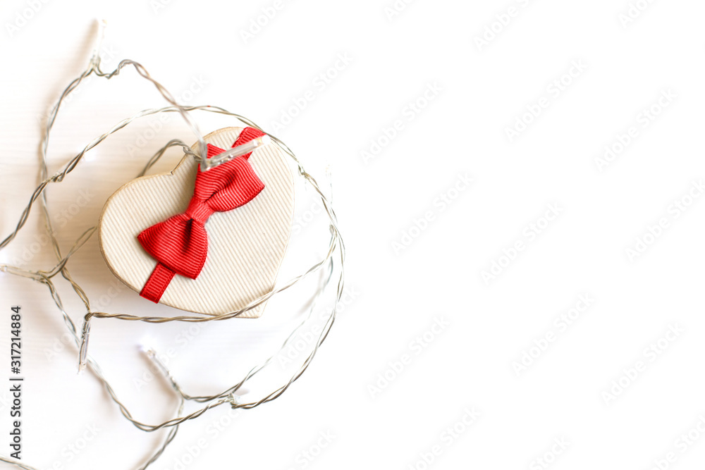 gift box in the form of a heart with a gray bow on a white background. place for your text gift box in the form of a heart with a gray bow on a white background. place for your text