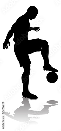 A soccer or football player in silhouette
