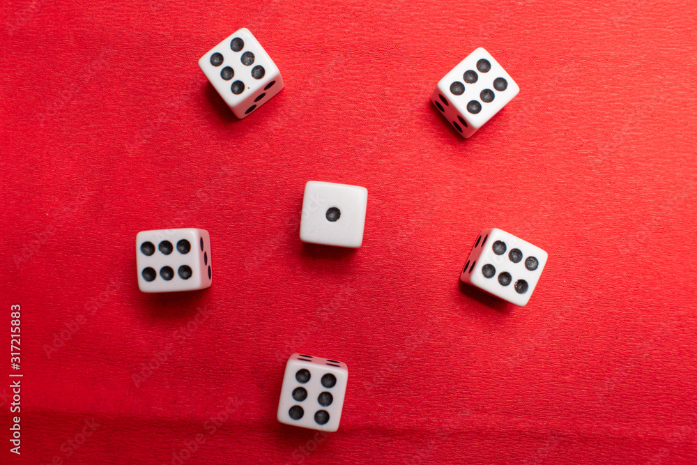 Hand throwing dice, hoping for the best odds. Six dice on red background Hand throwing dice, hoping for the best odds. Six dice on red background