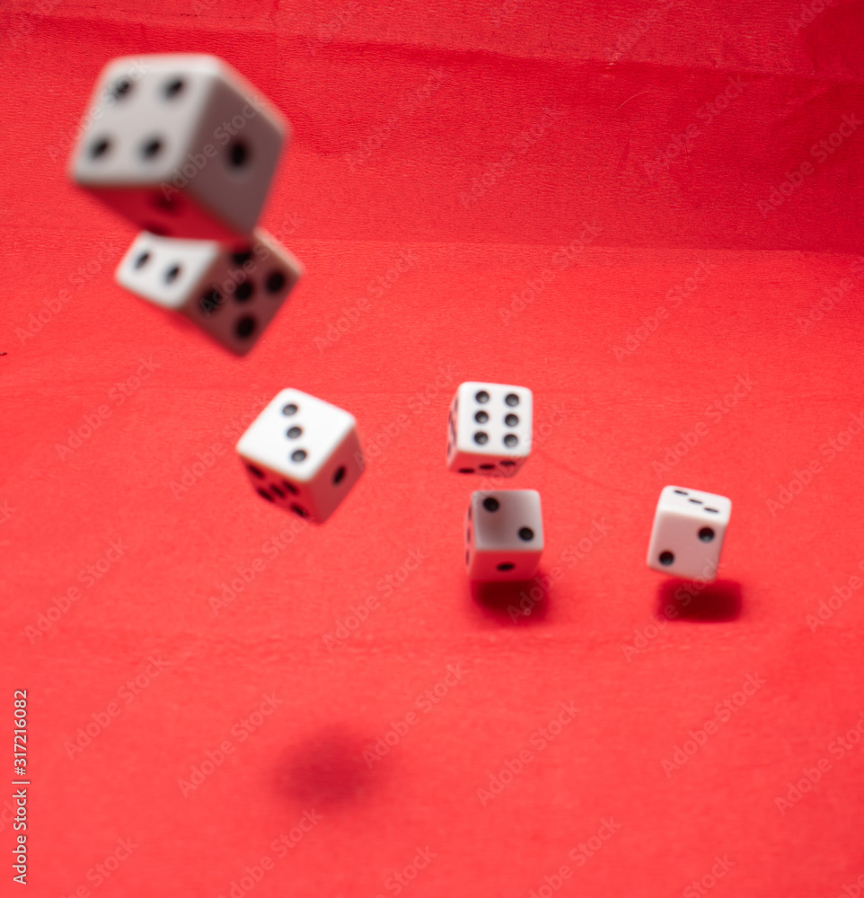 Hand throwing dice, hoping for the best odds. Six dice on red background Hand throwing dice, hoping for the best odds. Six dice on red background