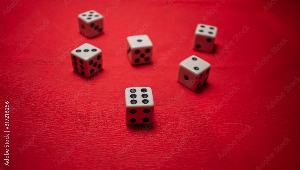 Hand throwing dice, hoping for the best odds. Six dice on red background Hand throwing dice, hoping for the best odds. Six dice on red background