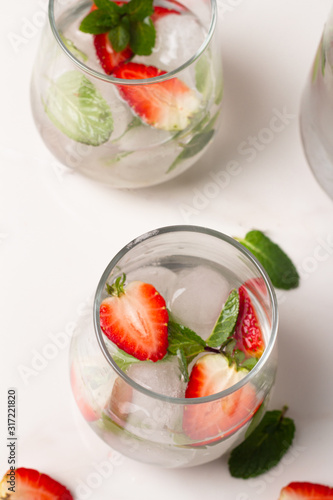 strawberries in a glass on white table