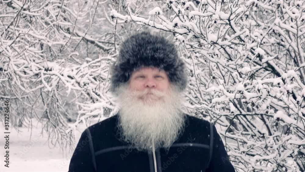 Elderly man jumping at winter snow-covered park in slow motion. Healthy cheerful senior retired person. Elderly man jumping at winter snow-covered park in slow motion. Healthy cheerful senior retired person.