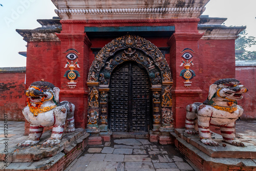 Traditional Nepali door of a temple. The door is deocrated with sculptures of Hindu Gods and creatures. © asiraj