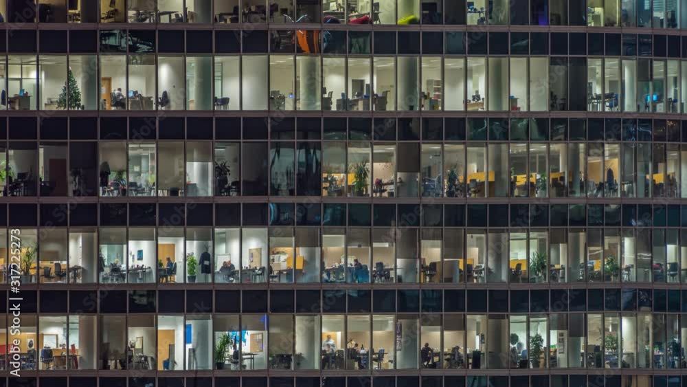 View of office windows with working people View of office windows with working people