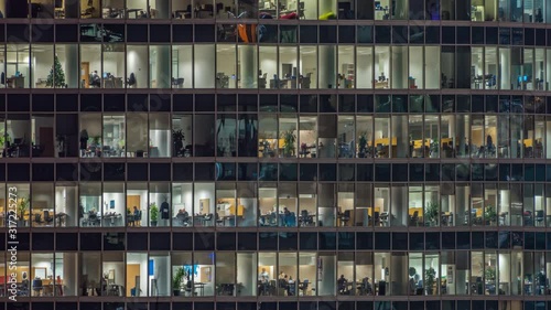 View of office windows with working people