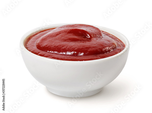 Tomato ketchup in a bowl isolated on white. photo