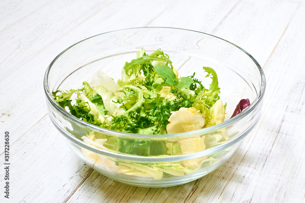 Vegetarian salad mix of fresh vegetables on a light wooden background. Healthy and wholesome organic food, diet, proper nutrition concept. Vegetarian salad mix of fresh vegetables on a light wooden background. Healthy and wholesome organic food, diet, proper nutrition concept.