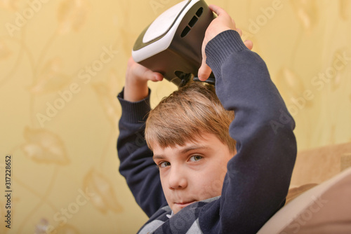 A child removes VR glasses after watching a 3D video