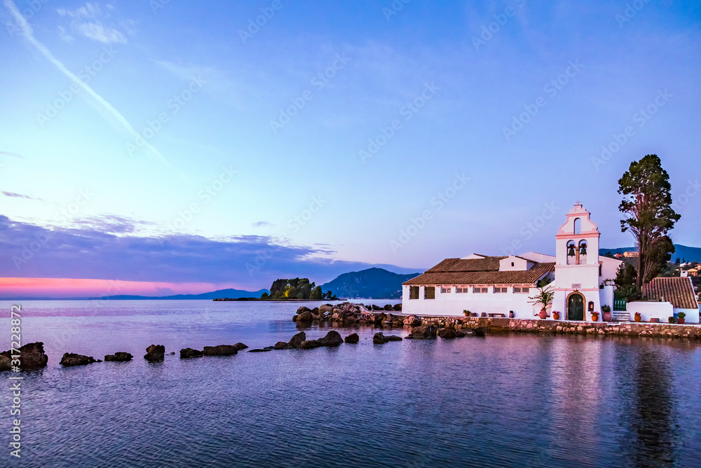 Early morning view of famous Vlachernа monastery, Pontikonissi or mouse island and Halikiopoulou lagoon. Kanoni, Corfu island, Greece.