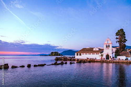 Early morning view of famous Vlachernа monastery, Pontikonissi or mouse island and Halikiopoulou lagoon. Kanoni, Corfu island, Greece. photo