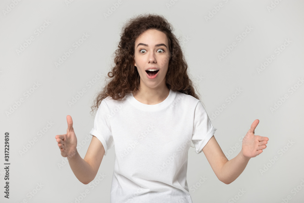 Amazed millennial woman demonstrating big measurement size. Amazed millennial woman demonstrating big measurement size.