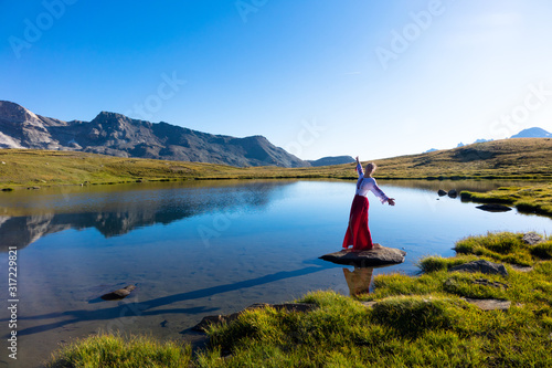 Young girl dancing in the mountains