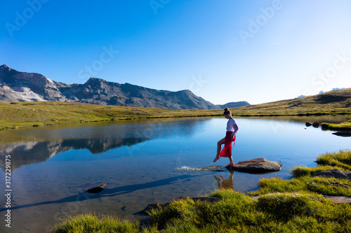 Young girl dancing in the mountains