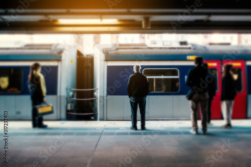 Blurry concept image of people travel by train on railway platform at  MTR train station in HongKong photo