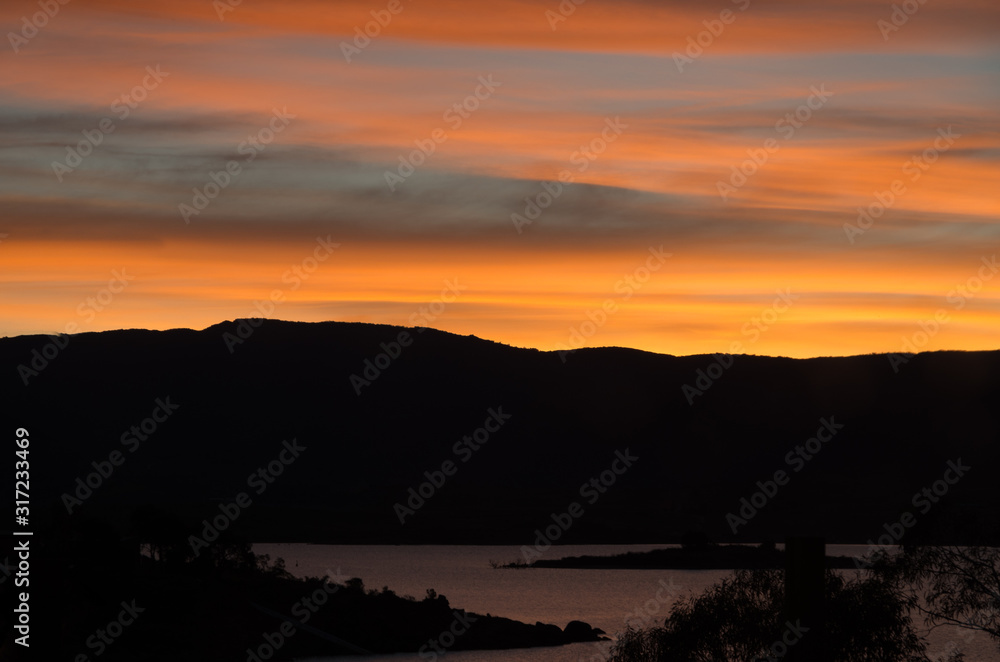 Bright oranges sunset by the Jndabyne lake Bright oranges sunset by the Jndabyne lake