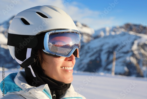 Portrait of a young attractive woman in a ski suit and helmet © Alexey Kuznetsov