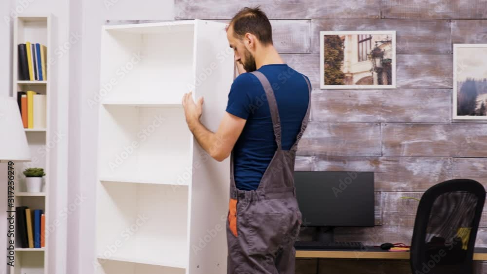 Male worker checking new furniture after assambly Male worker checking new furniture after assambly
