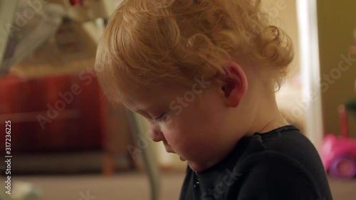 Little boy drooling toddler baby curly blond hair 1 year european caucasian white closeup