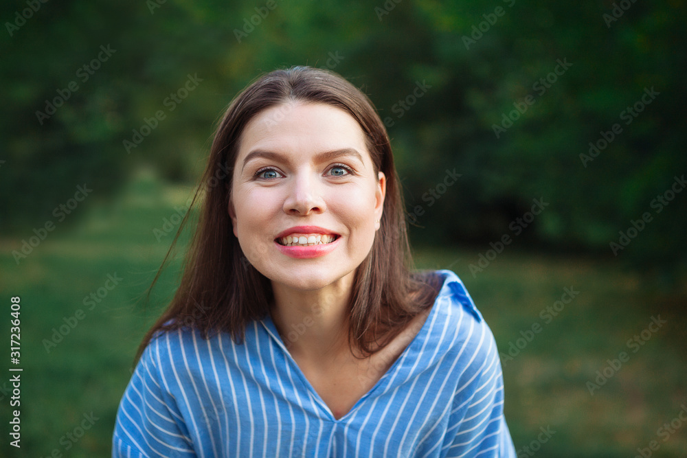 Beautiful Young Woman Outdoors. Enjoy Nature. Healthy Smiling Girl in Green Grass. Face young beautiful girl dark closeups short hair summer park smiling. Beautiful Young Woman Outdoors. Enjoy Nature. Healthy Smiling Girl in Green Grass. Face young beautiful girl dark closeups short hair summer park smiling.