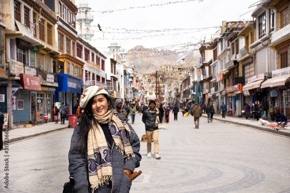 Travelers thai women travel visit and posing portrait for take photo on street in Leh main bazaar at Leh Ladakh village on March 19, 2019 in Jammu and Kashmir, India