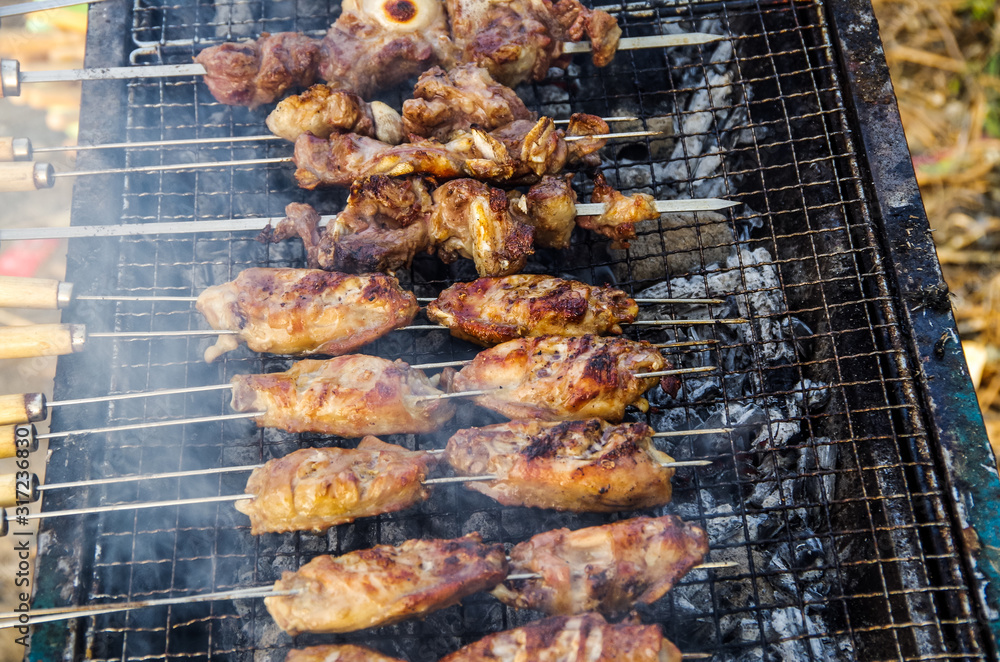 Delicious outdoor roast chicken wings and lamb